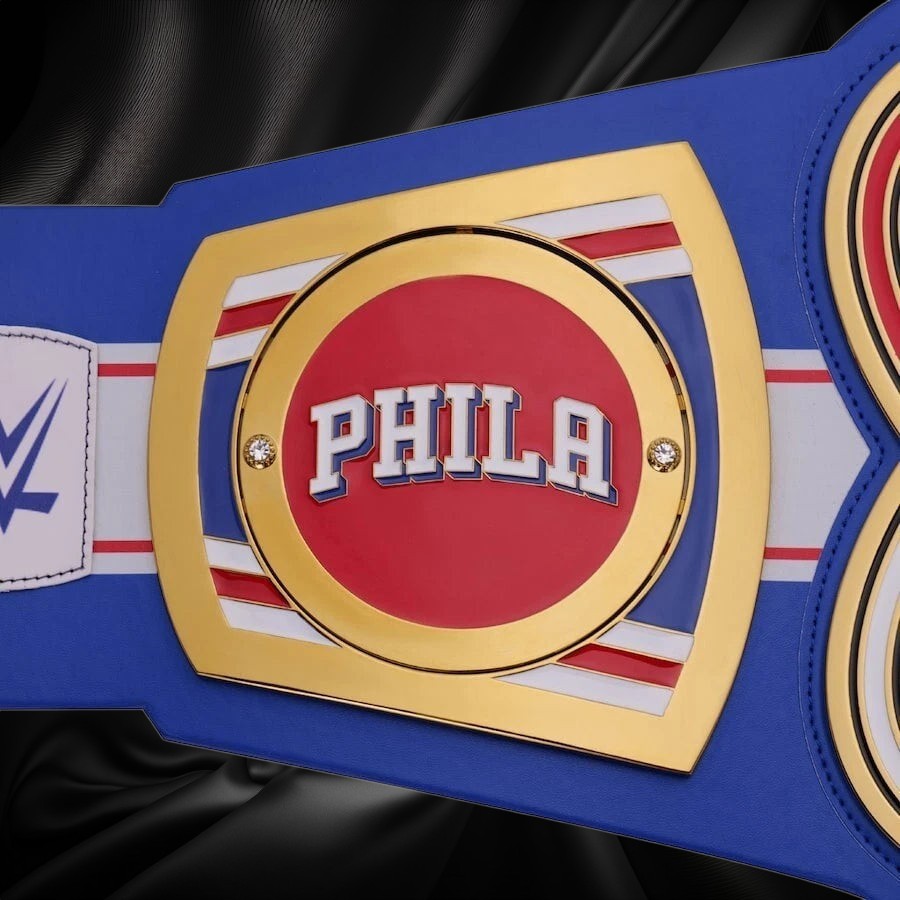 Blue championship belt with a red center displaying 'PHILA' on a white background