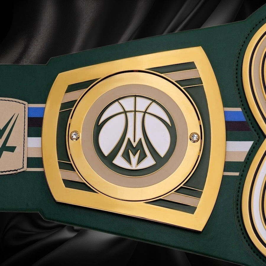 Close-up of a championship belt with a prominent logo on a white background