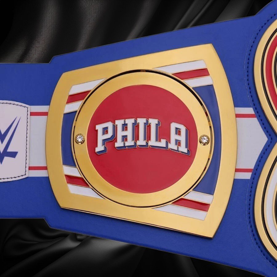 s-l960_65_a3186b1d-70d8-43e3-b48c-4f2c9c50e965 Blue championship belt with a red center displaying 'PHILA' on a white background